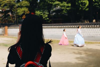 Rear view of women sitting outdoors