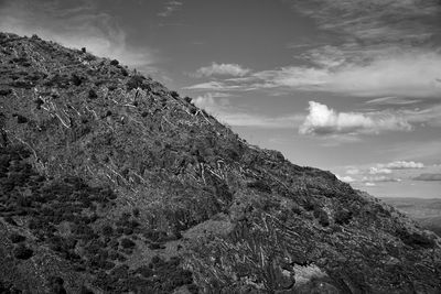 Rock formations in black and white against sky