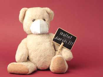 Close-up of stuffed toy against red background