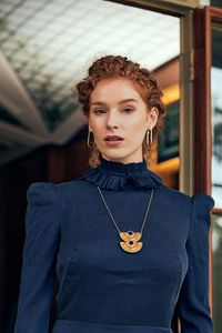 Portrait of beautiful young woman standing indoors