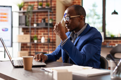 Worried businessman sitting at desk in office