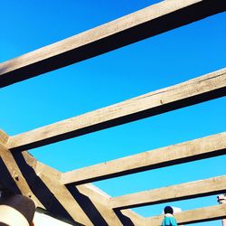 Low angle view of bridge against blue sky
