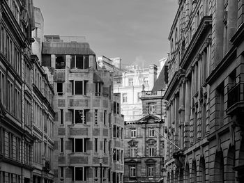 Low angle view of buildings in town against sky