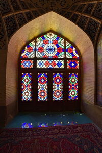 Low angle view of stained glass window in building