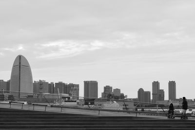 City skyline against cloudy sky