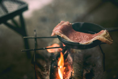 Steak being cooked in a skillet at camp