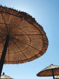 Low angle view of parasol against clear sky