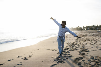 Full length of man standing on beach