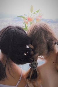 Rear view of woman with pink flowers