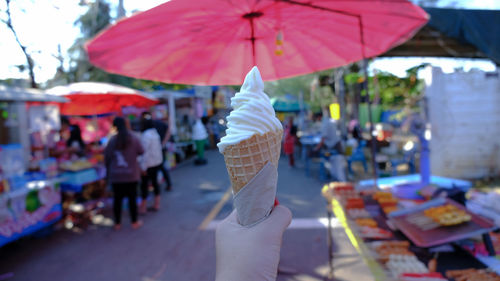 Rear view of woman and ice cream cone at market