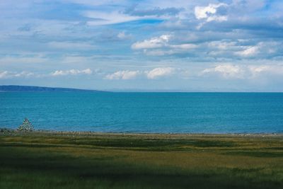 Scenic view of sea against cloudy sky