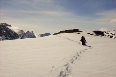 Full length of person on snowcapped mountain against sky