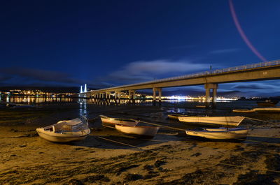 Bridge over sea against sky at night