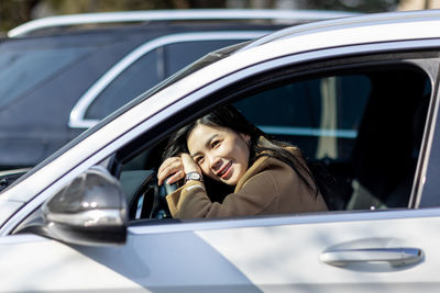 Portrait of young woman in car