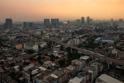 High angle view of buildings in city against sky during sunset