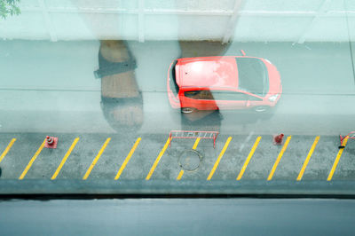 Car parked on street seen through window