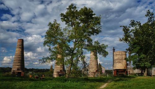 Built structure on field against sky