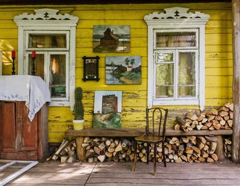 Stack of logs against building