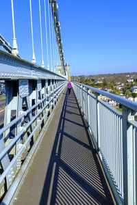 The menai bridge connecting the island of anglesey  to the welsh mainland.