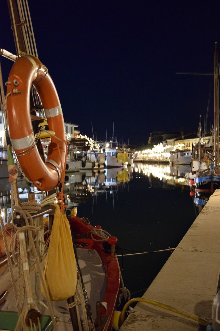 BOATS MOORED IN HARBOR AT MARINA