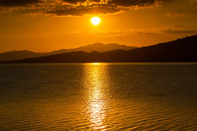 Scenic view of sea against romantic sky at sunset