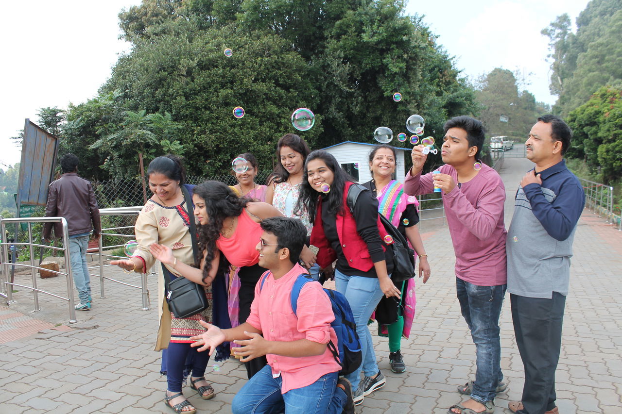 GROUP OF PEOPLE ENJOYING ON THE GROUND