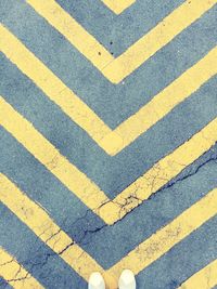 High angle view of yellow lines on road