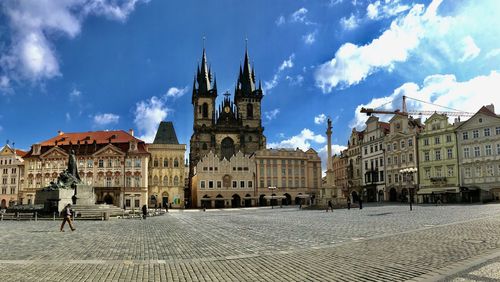 Panoramic view of buildings in town against sky