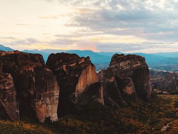 Rock formations on landscape against sky