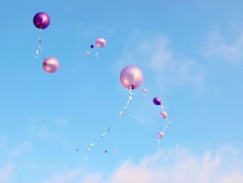 Low angle view of balloons against sky