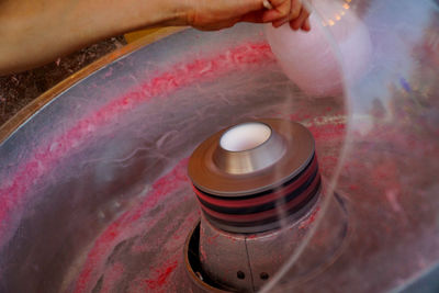Close-up of hand spinning candy floss