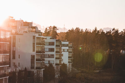 Buildings against sky during sunset in city