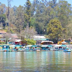 Boats in river with buildings in background