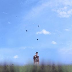 People on field against cloudy sky