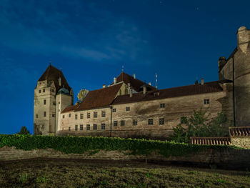 Low angle view of buildings against sky at night