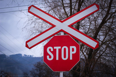 Close-up of road sign against sky