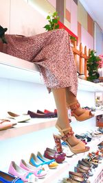 Low section of woman in high heels at store