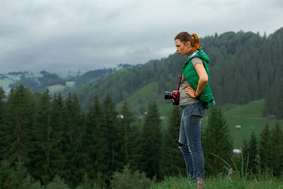 Girl photographer in the carpathian mountains shoots a landscape
