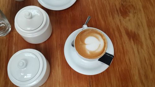 Directly above shot of coffee cup on wooden table