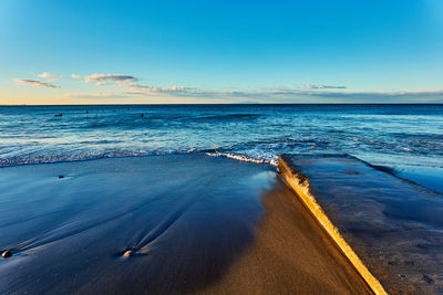 Scenic view of sea against blue sky