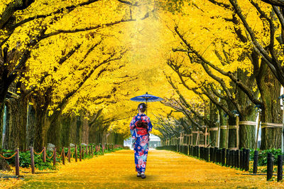 Full length of man standing in park during autumn