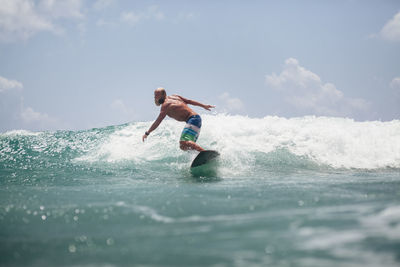 Man in sea against sky