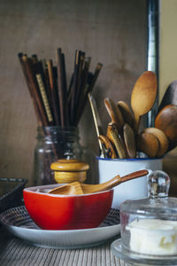 Close-up of bowls and wooden spoons on table