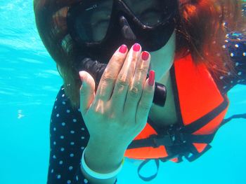 Close-up of woman scuba diving in sea