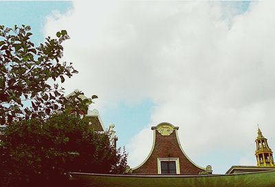 Low angle view of church against cloudy sky