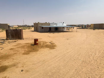 Built structure on beach against clear sky