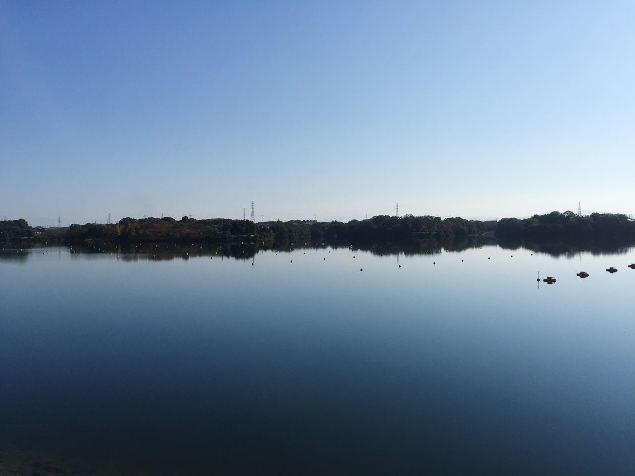 clear sky, copy space, water, reflection, waterfront, tranquil scene, tranquility, lake, scenics, beauty in nature, nature, blue, standing water, calm, idyllic, outdoors, no people, river, dusk, remote