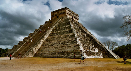 Low angle view of historical building against cloudy sky