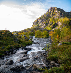 Scenic view of waterfall against sky