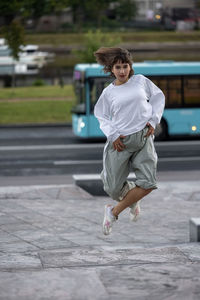 Portrait of young woman walking on street